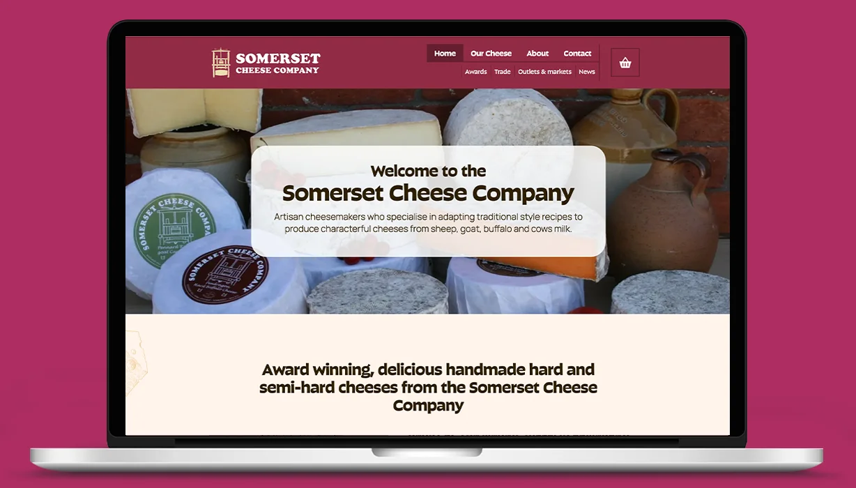 A website design for the Somerset Cheese Company, displayed on a laptop.